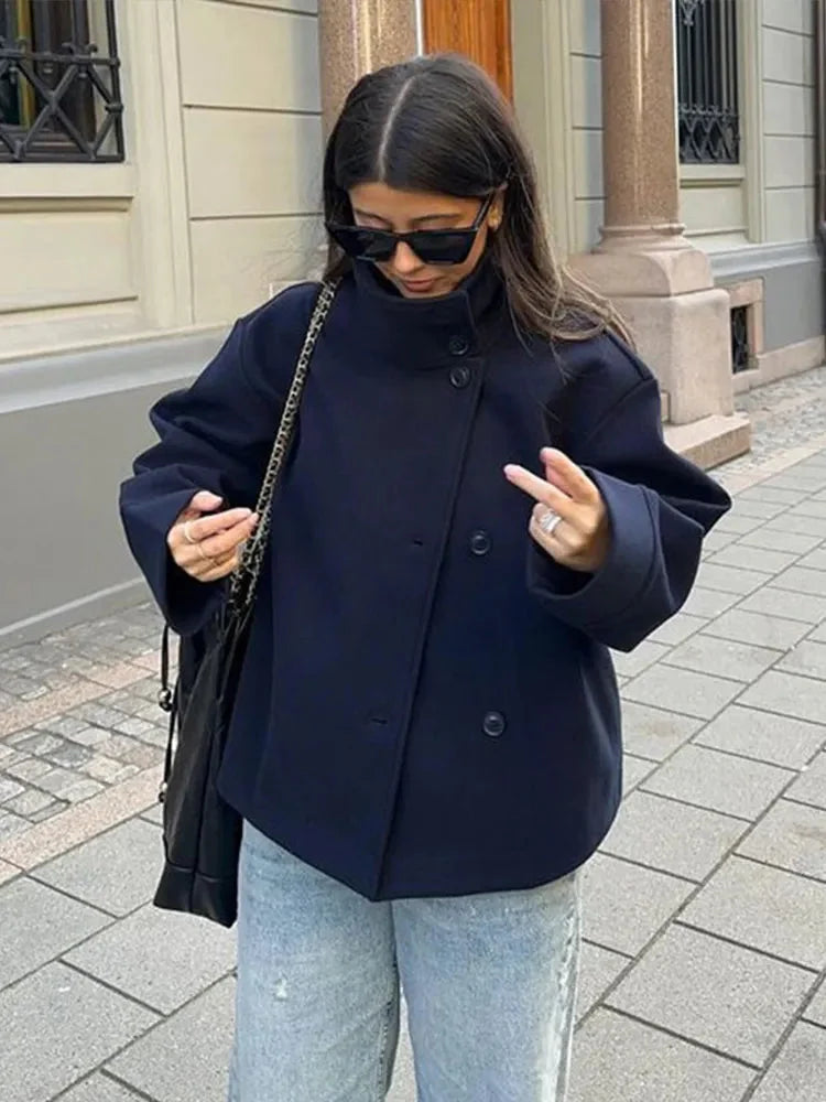 Women's stand collar single-breasted loose jacket made from lightweight fabric, featuring spacious pockets and a relaxed fit.