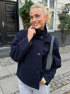 Women's stand collar single breasted loose jacket in lightweight fabric, featuring a minimalist design and versatile style.