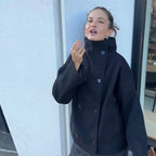 Women's stand collar single breasted loose jacket made of lightweight fabric with a relaxed fit for everyday wear.