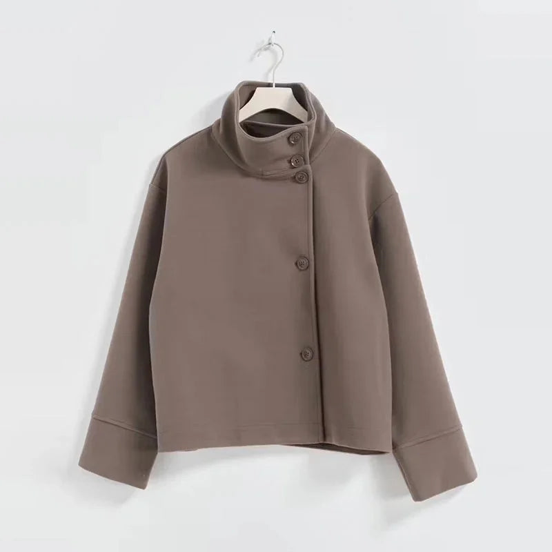Women's stand collar single-breasted loose jacket made from soft cotton blend, featuring a relaxed fit and button closure.