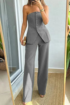 Gray women's strapless asymmetric pantsuit with buttons and pockets, made from a comfortable blend of polyester and spandex.