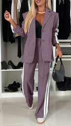 Women's striped blazer and pant set featuring functional pockets, crafted from breathable fabric for comfortable wear.