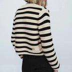 Women's striped button-up cardigan with round neckline, crafted from soft cotton blend, featuring a classic fit and ribbed…
