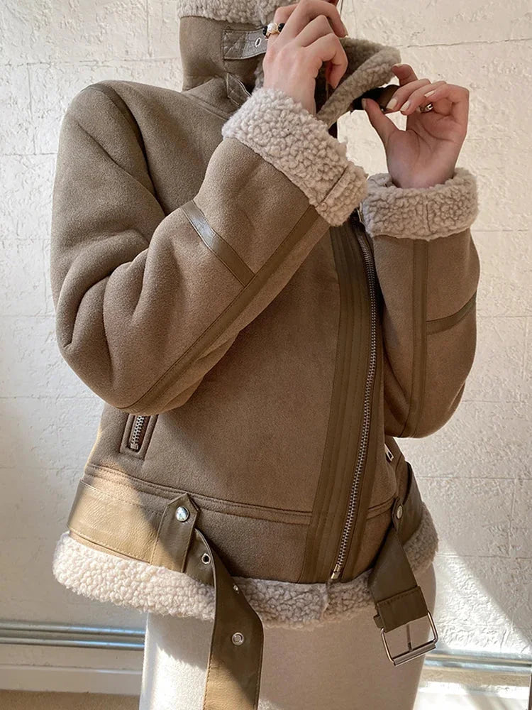 Women's suede jacket featuring a faux shearling lining and a zip closure for added warmth and style.