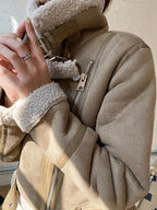 Women's suede jacket featuring a faux shearling lining and zip closure, designed for warmth and stylish layering options.
