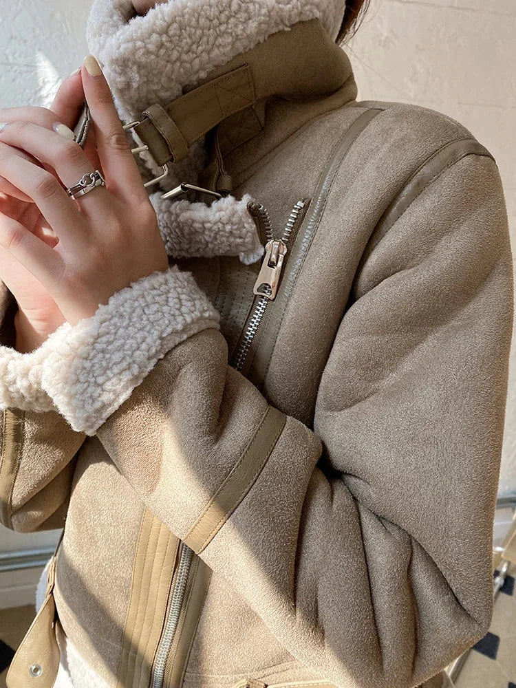 Women's suede jacket featuring a faux shearling lining and zip closure, designed for warmth and stylish layering options.