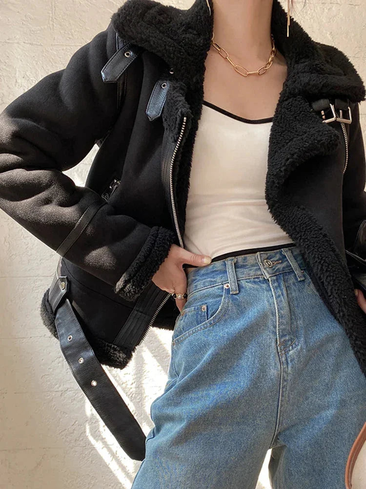 Women's suede jacket featuring faux shearling lining and zip closure, designed for warmth and comfort in cooler weather.