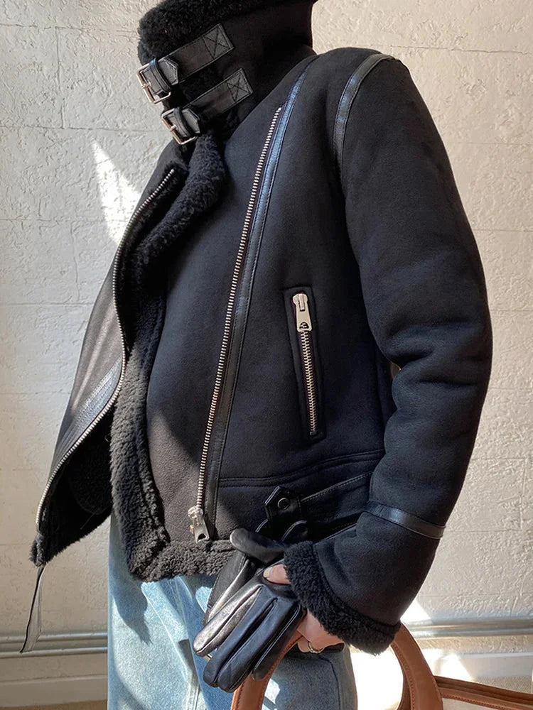 Women's suede jacket featuring faux shearling lining, zip closure, and a stylish design for added warmth and comfort.
