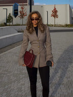 Women's tailored plaid blazer made from a soft fabric, featuring distinctive gold buttons and a classic, structured fit.