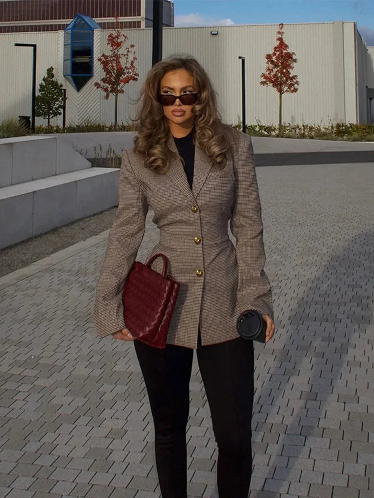 Women's tailored plaid blazer made from a soft fabric, featuring distinctive gold buttons and a classic, structured fit.