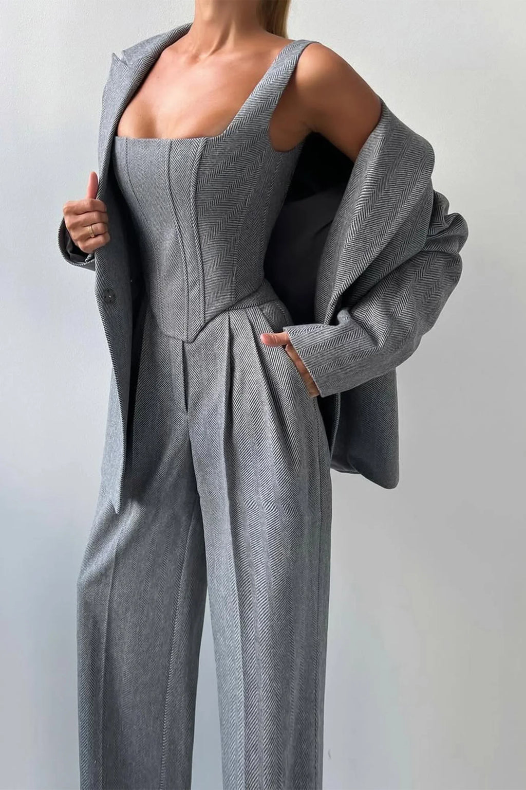 Women's tailored three-piece set featuring a fitted top, made from breathable fabric with a classic cut and sophisticated…
