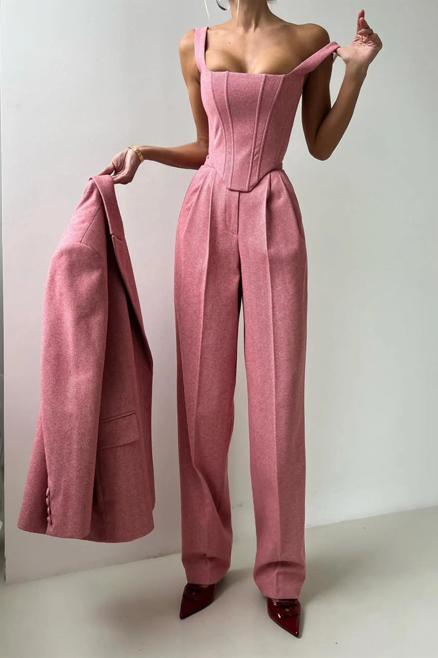 Women's tailored three-piece set featuring a fitted top, made of breathable fabric with structured design and elegant lines.