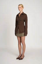 Women's tailored wrap blouse with long sleeves, made of soft cotton blend, featuring a fitted silhouette and elegant tie…