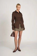 Women's tailored wrap blouse in soft cotton with long sleeves and a flattering silhouette for versatile styling.