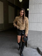 Women's tan cropped jacket featuring front pockets, made from lightweight cotton blend, ideal for casual wear.
