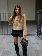 Women's tan cropped jacket made of soft fabric featuring front pockets and a stylish, modern cut. Perfect for layering.