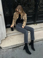 Women's tan cropped jacket made of soft cotton blend, featuring front pockets and a stylish, tailored design.