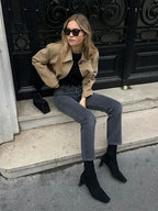 Women's tan cropped jacket made from durable cotton, featuring front pockets and a stylish, fitted design.