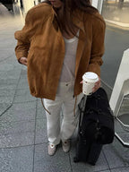 Women's tan standneck jacket with zipper, long sleeves, made from soft fabric for comfort and style, ideal for cooler days.