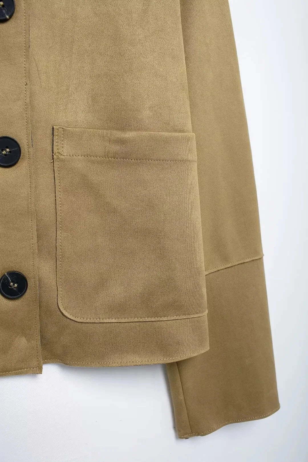 Women's tan suede long sleeve button-up jacket with a classic collar and chest pockets for added style and functionality.