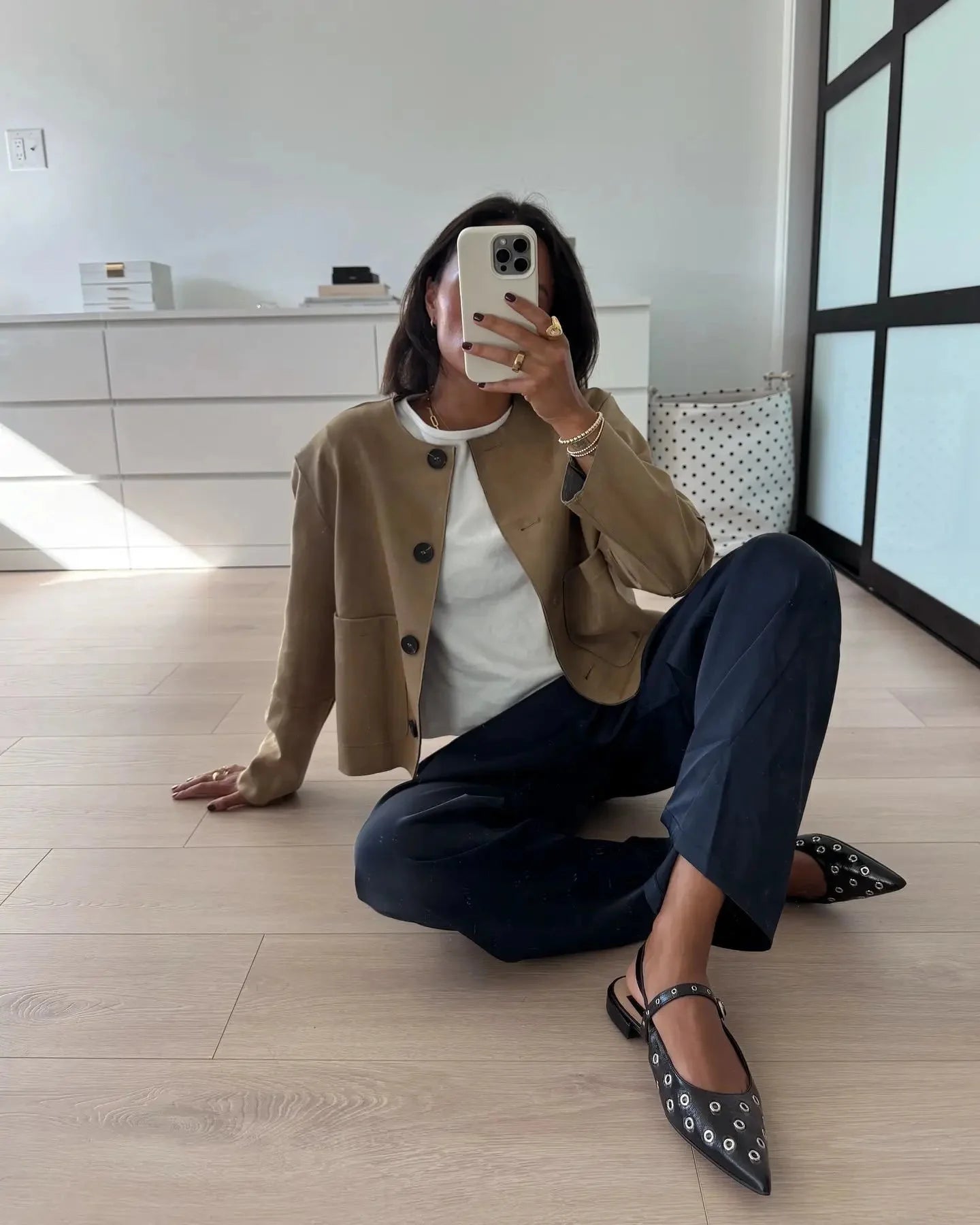 Women's tan suede long sleeve button-up jacket featuring a classic collar and side pockets for a stylish, casual look.
