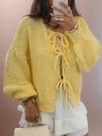 Women's tie-front knitted cardigan in soft fabric with oversized sleeves and a relaxed fit, perfect for layering.