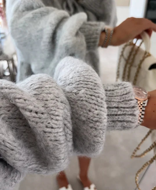 Women's knitted cardigan with tie front, oversized sleeves, made from soft fabric for comfortable layering in cooler weather.