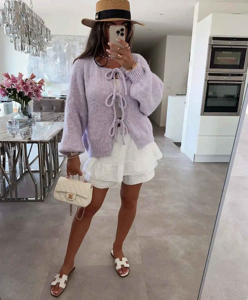 Women's knitted cardigan with tie-front, oversized sleeves, made from soft, breathable fabric for comfort and style.