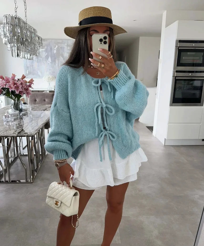 Women's knitted cardigan with tie-front detail, oversized sleeves, made from soft, breathable yarn for comfort and style.