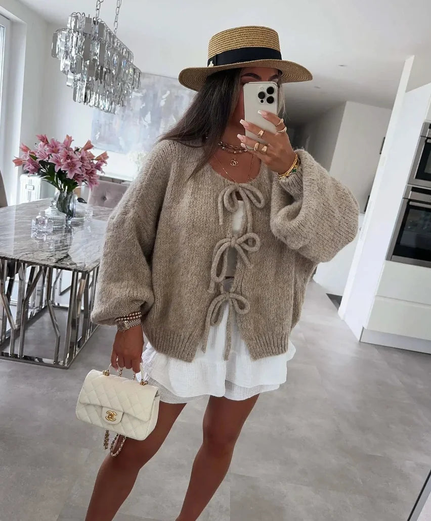 Women’s tie-front knitted cardigan featuring oversized sleeves and a cozy, soft fabric for a relaxed fit and stylish look.