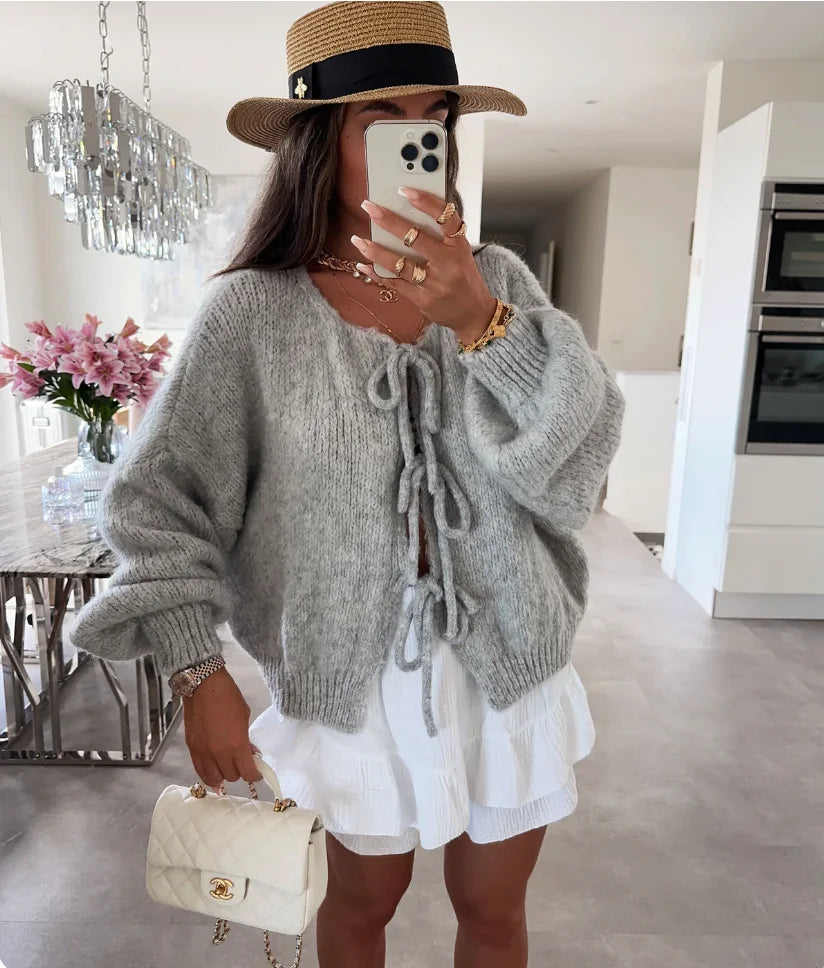 Women's knitted cardigan with tie-front, oversized sleeves, made from soft, breathable fabric for comfort and style.