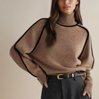 Women’s turtleneck knit sweater featuring contrast trim, crafted from soft acrylic for warmth and comfort in cooler weather.