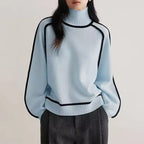 Women's turtleneck knit sweater featuring contrast trim, made of soft acrylic for warmth and comfort during cooler days.