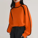 Women's turtleneck knit sweater featuring contrast trim and a soft fabric blend for comfort and warmth.