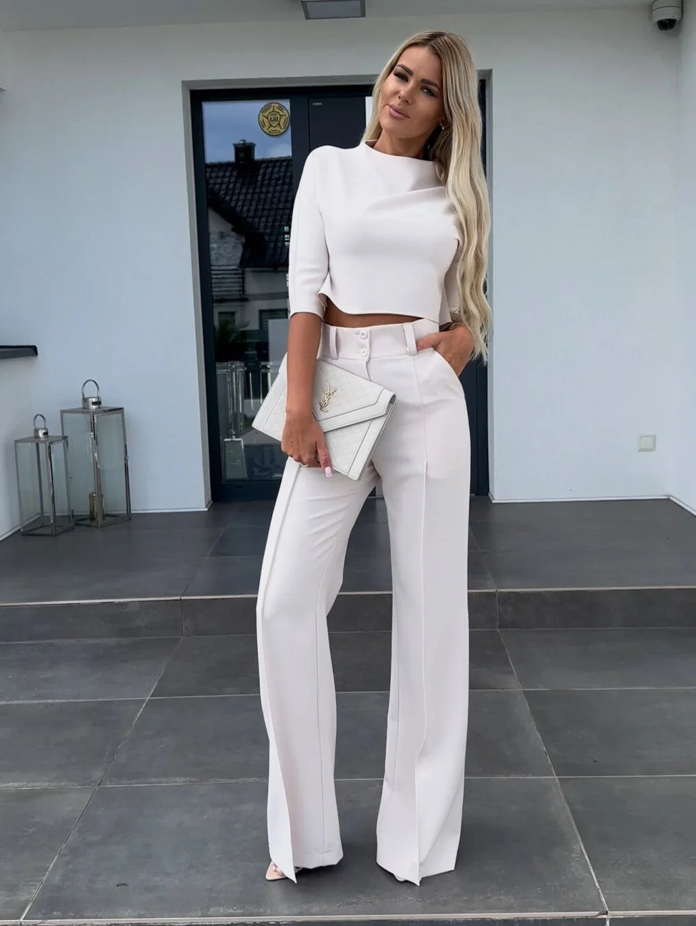 Women's two-piece set featuring high-waist pants and a cropped top made from soft, breathable cotton blend fabric.