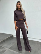 Women's two-piece set featuring high-waist pants and a cropped top, made from soft cotton blend with a chic, trendy design.