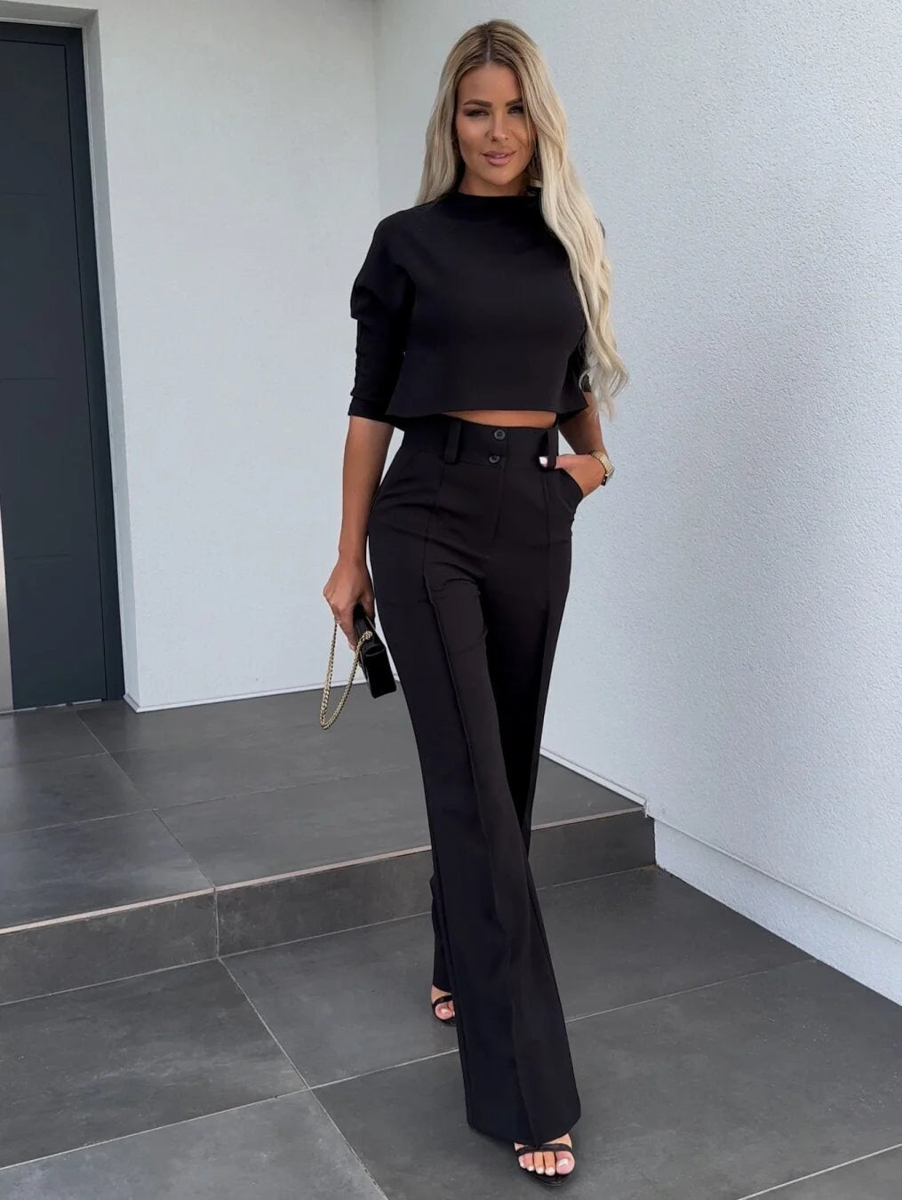 Women's two-piece set featuring high-waist pants and a cropped top made from soft, breathable cotton blend with a relaxed…