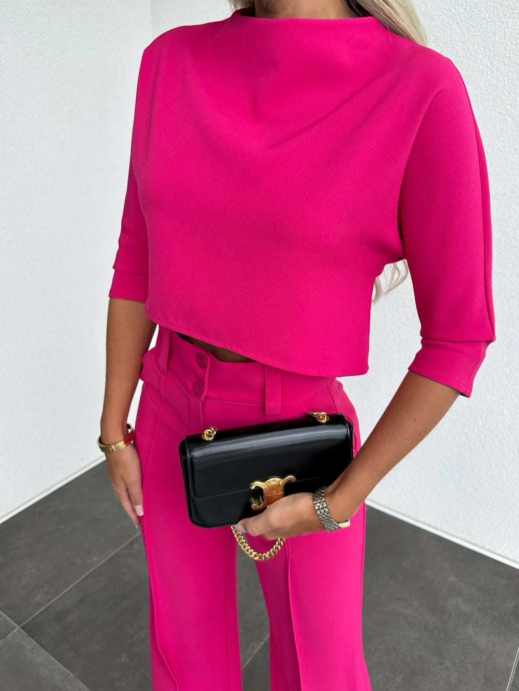 Women's two-piece set featuring high-waist pants and a cropped top, made from lightweight cotton blend, ideal for casual…