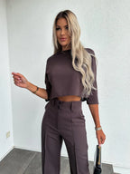 Women's two-piece set featuring high-waist pants and a cropped top made from soft, breathable cotton in a modern design.