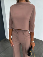 Women's two-piece set featuring high-waist pants and a cropped top, crafted from soft cotton with a relaxed fit for comfort.