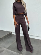 Women's two-piece set featuring comfortable cotton blend material, high-waist pants, and a stylish cropped top design.