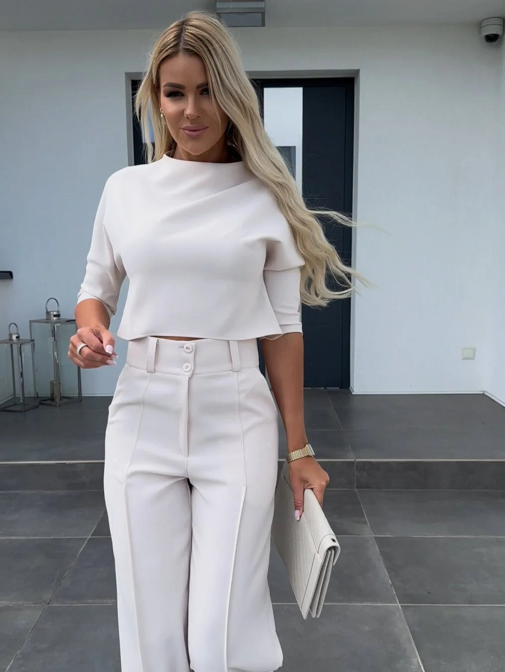 Women's two-piece set featuring high-waist pants and a cropped top, made from soft cotton with a stylish, relaxed fit.