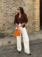 Women's V-neck cardigan featuring unique button trim, crafted from soft, lightweight fabric for comfortable layering.