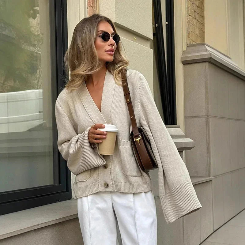 Women's V-neck loose cardigan in soft knit with button details, ideal for layering and casual wear in various colors.