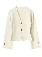 Women's V-neck loose cardigan in soft knit, featuring button details and a relaxed fit for comfortable layering.