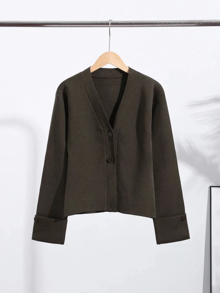 Women's V-neck loose cardigan featuring button details, crafted from soft knit fabric for comfort and easy layering.