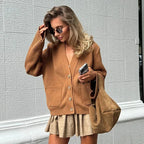 Women's V-neck loose cardigan made of soft knit fabric, featuring button details for style and versatility in everyday wear.