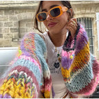 Women's vibrant striped cardigan featuring wide sleeves, made from soft knit fabric for comfort and style.