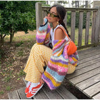 Women's vibrant striped cardigan featuring wide sleeves, crafted from soft, breathable fabric for comfort and style.