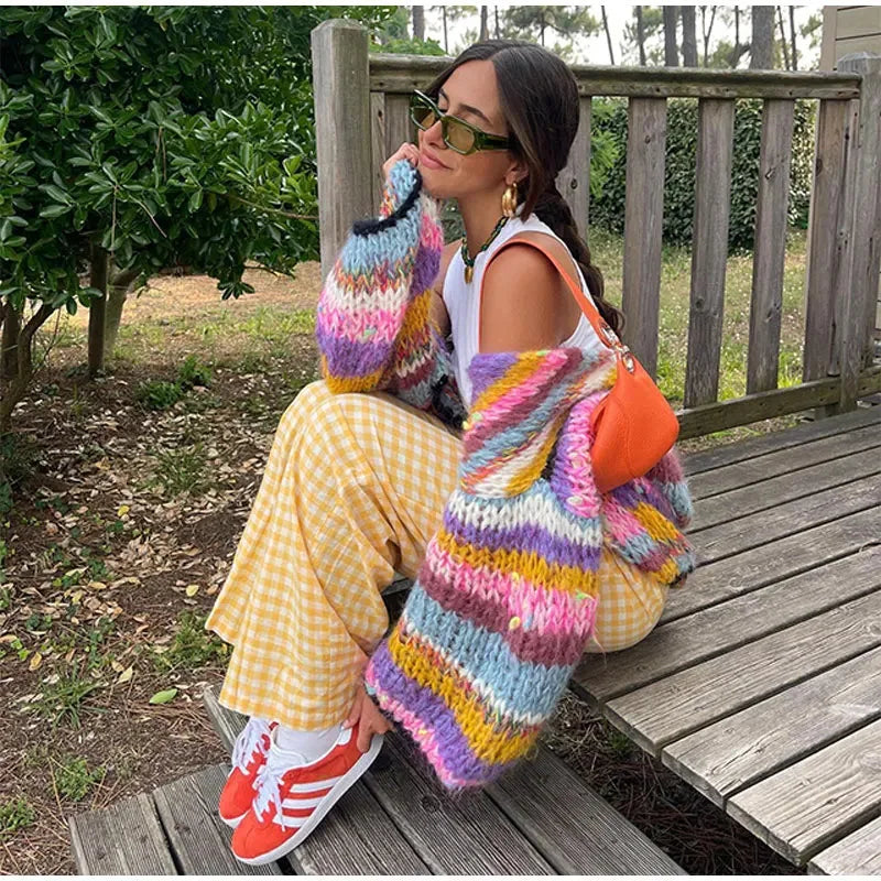 Women's vibrant striped cardigan featuring wide sleeves, crafted from soft, breathable fabric for comfort and style.